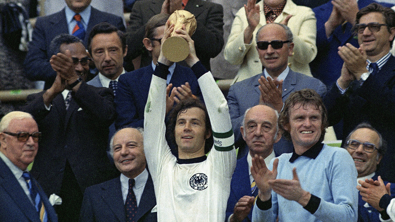 West Germany's national football team captain, Franz Beckenbauer, holds up the World Cup trophy after they defeated the Netherlands 2-1 in the World Cup soccer final on July 7, 1974, at Munich's Olympic stadium in Germany. Applauding at right, German goalkeeper Josef &quot;Sepp&quot; Maier and from left: FIFA president Sir Stanley Rous and German president Walter Scheel, smiling. (AP Photo)
